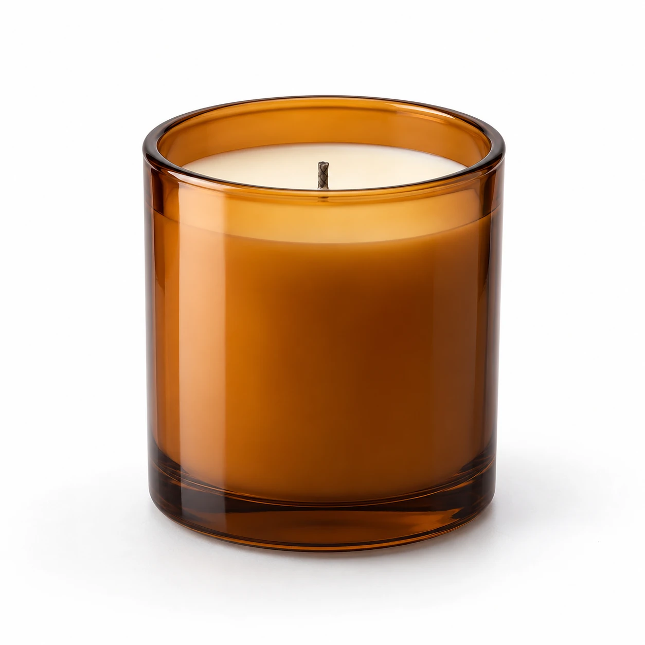 Unlit amber jar with ivory wax on a white background