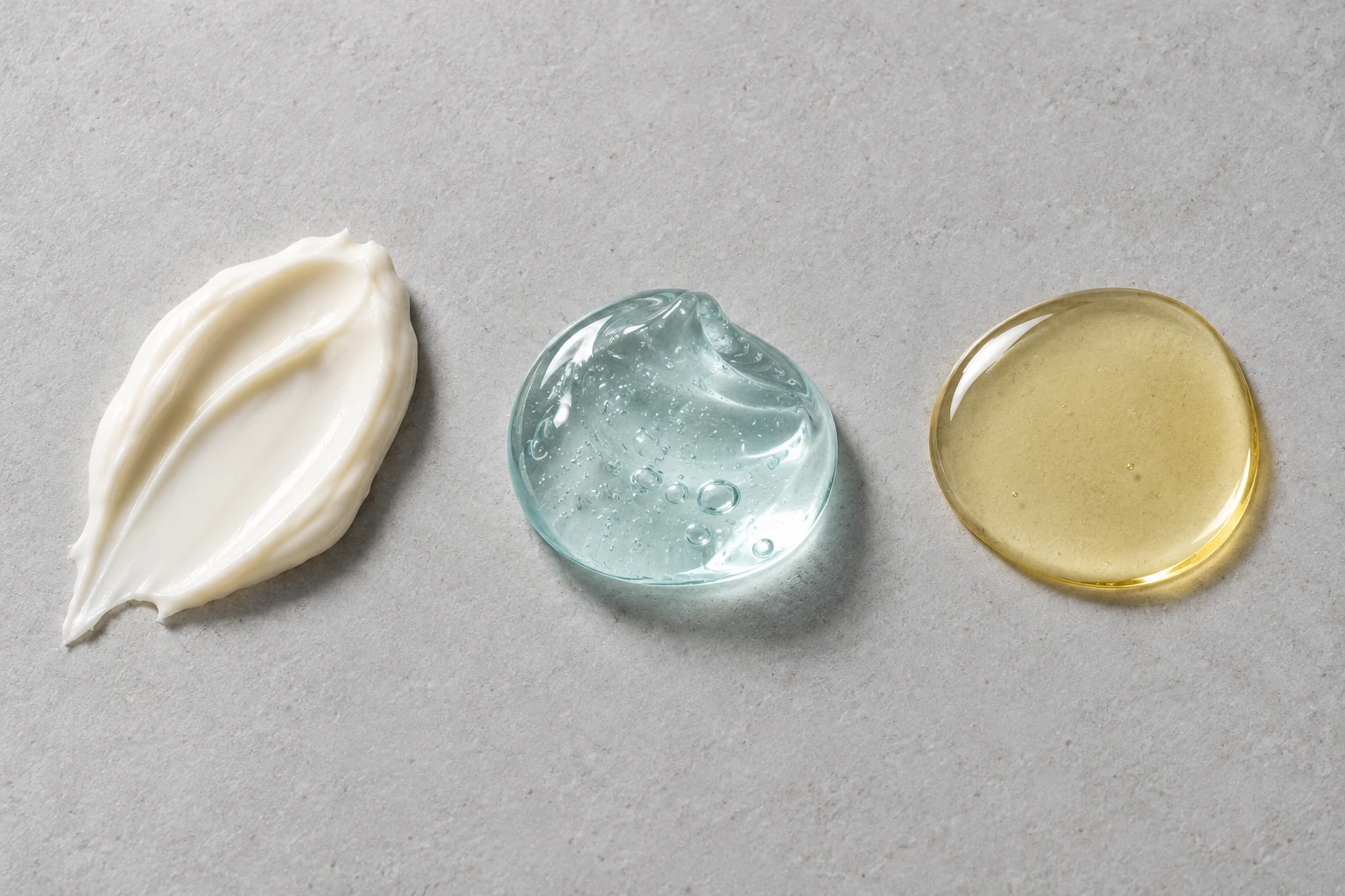 Three separate skincare samples showing opaque cream, translucent gel and a shallow oil pool